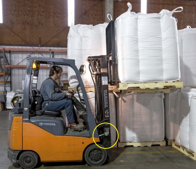 Operator using a Toyota forklift to store a load. The Toyota tilt cylinder is highlighted 